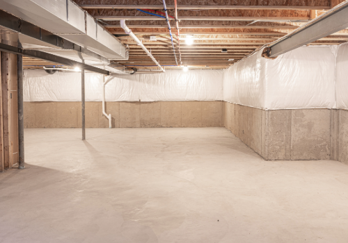 Basement Waterproofing Services by Story Roofing Finished basement with waterproofed walls and sealed floors, showcasing clean and protected concrete surfaces.